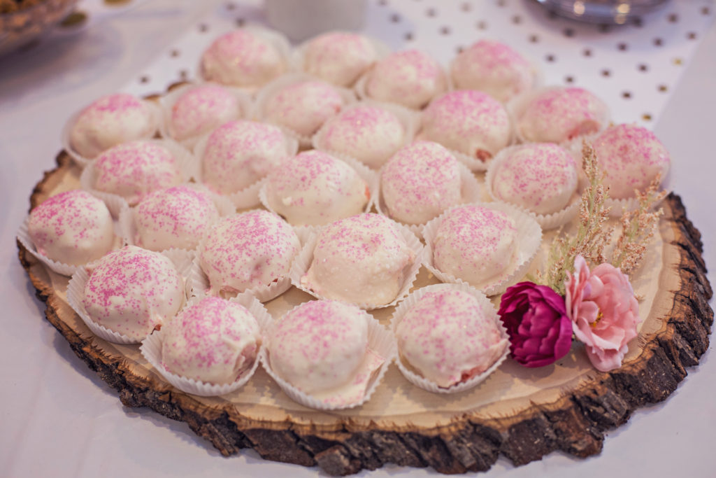strawberry cake balls dipped in white chocolate