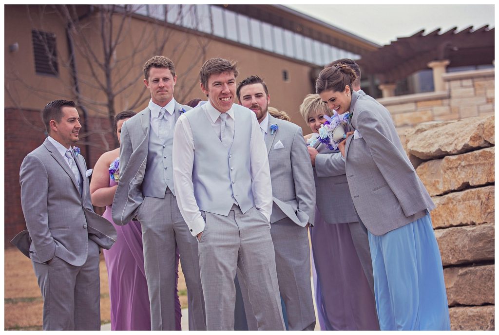 wedding party huddled together for warmth