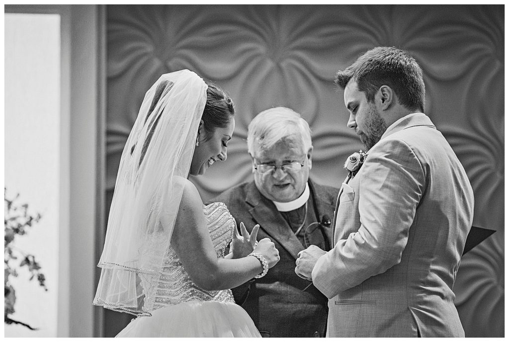 bride and groom exchanging rings