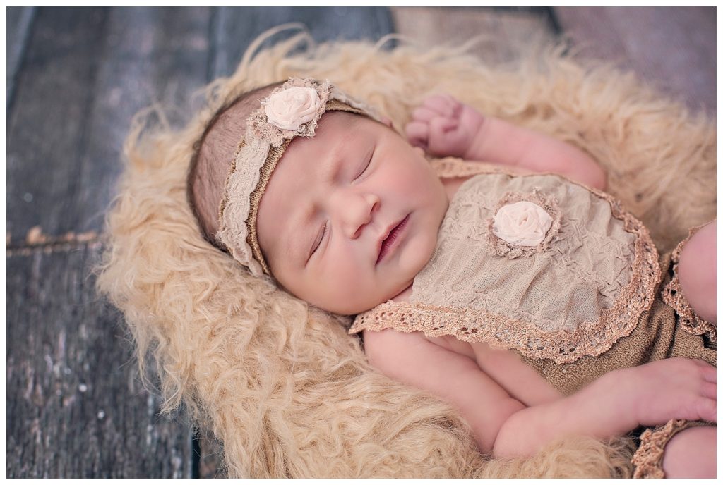 newborn baby girl on fluffy blanket