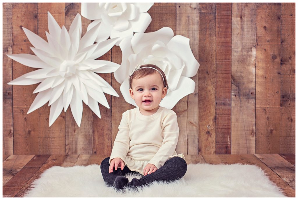 one year old girl with paper flowers