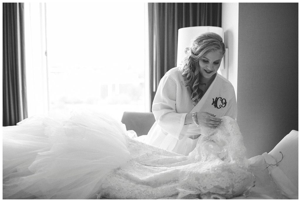 bride getting ready to put on her dress