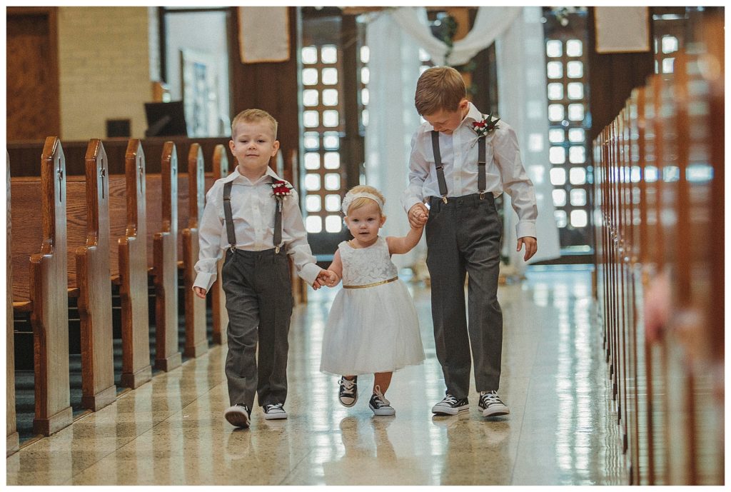 ring bearers walking down the flower girl