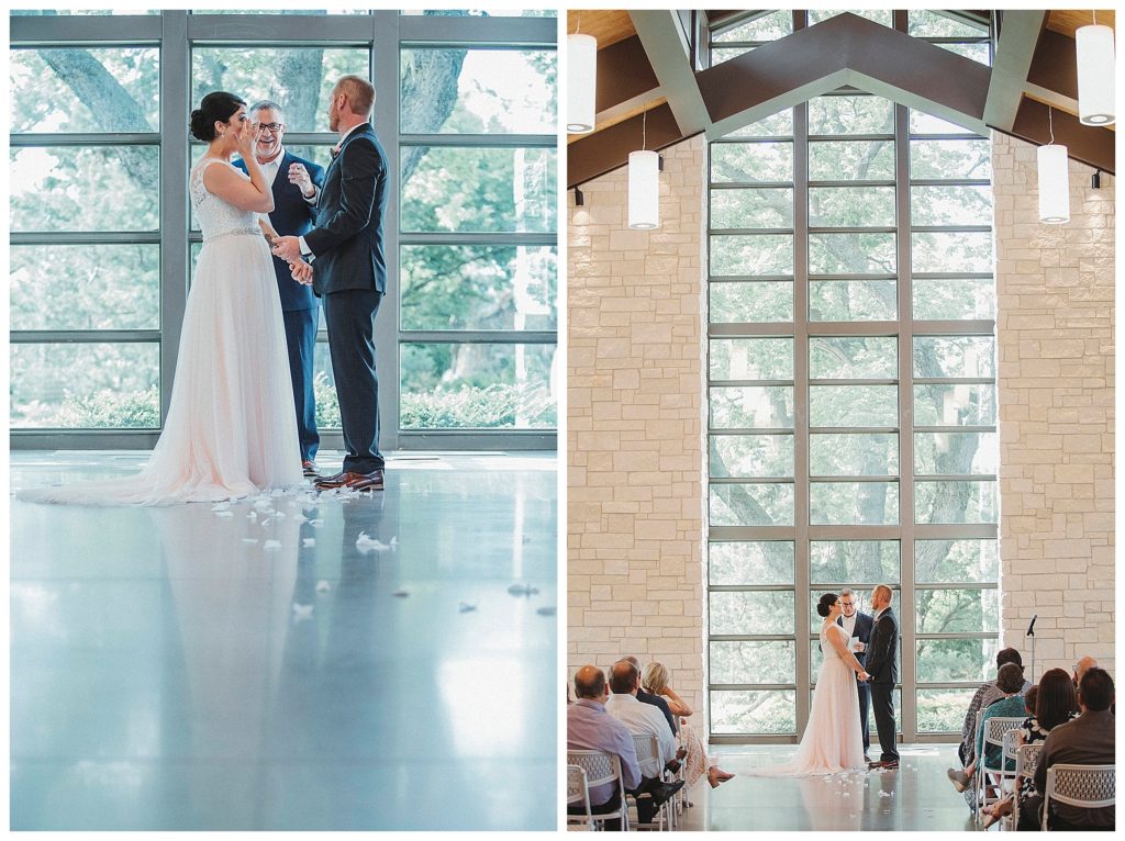 bride and groom in front of large windows