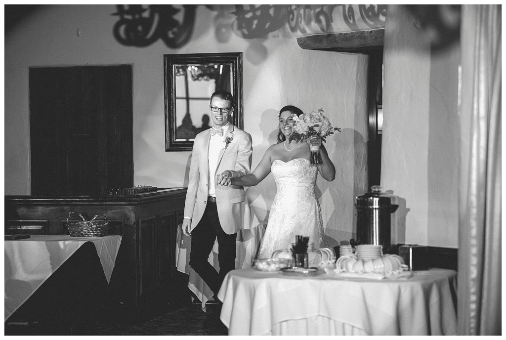 bride and groom entering their reception