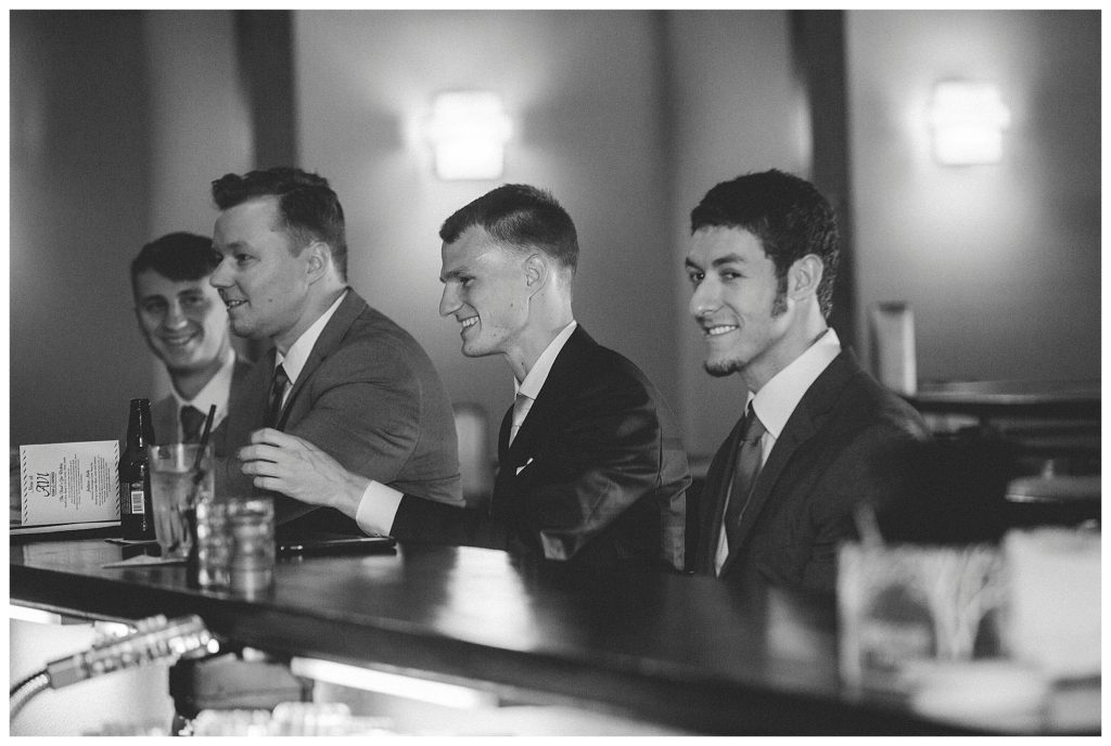 groom and groomsmen at the bar