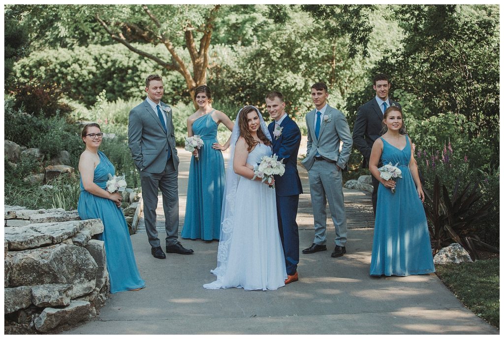 bridal party standing on bridge