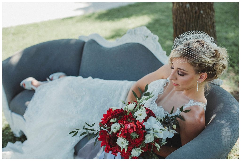 bride laying on vintage sofa