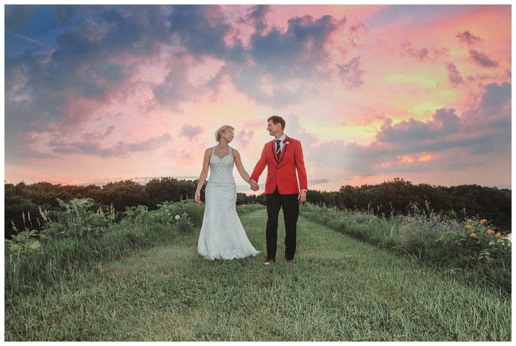 bride and groom walking at sunset