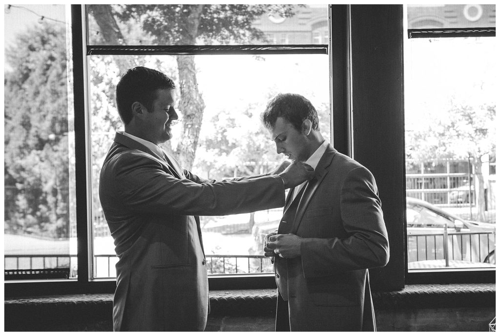 adjusting the grooms tie