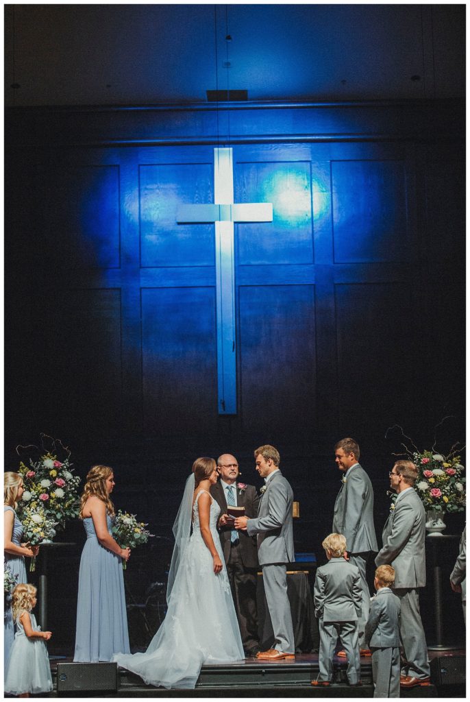 wedding ceremony under a cross
