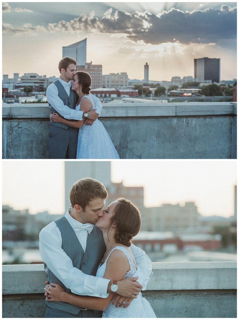 bride and groom on top of parking garage at sunset