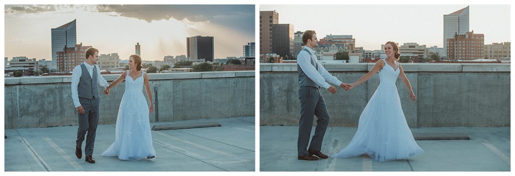 bride and groom on top of parking garage at sunset