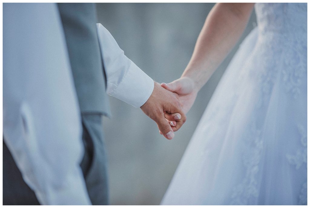 bride and groom holding hands