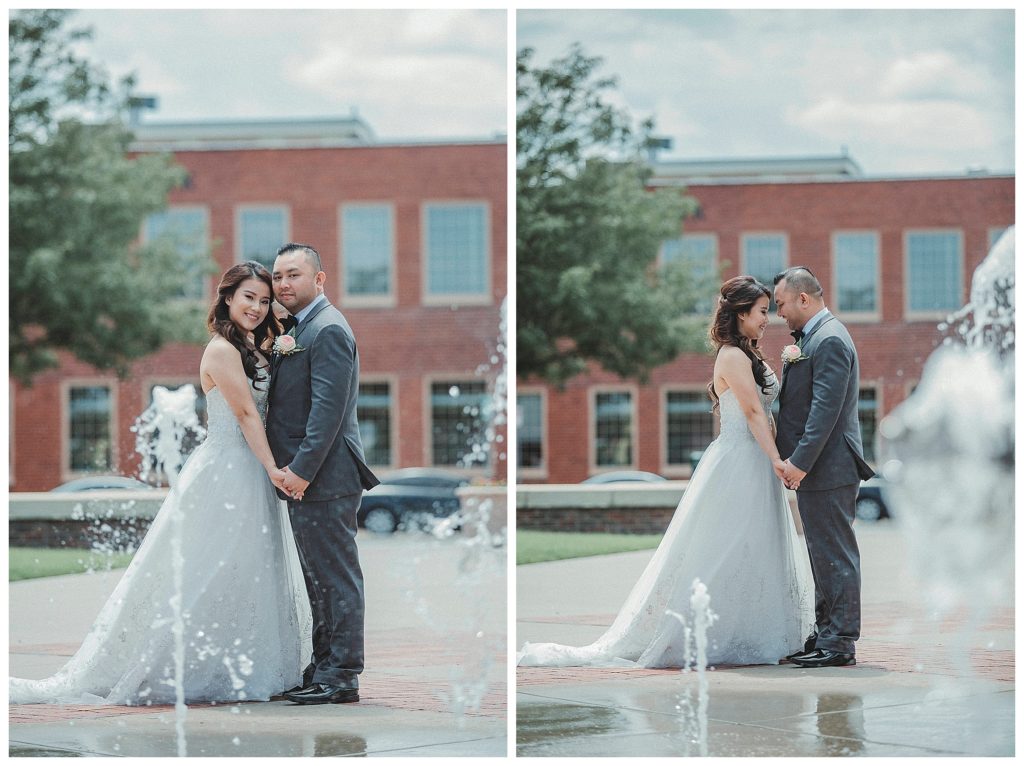 bride and groom posing by splash pad