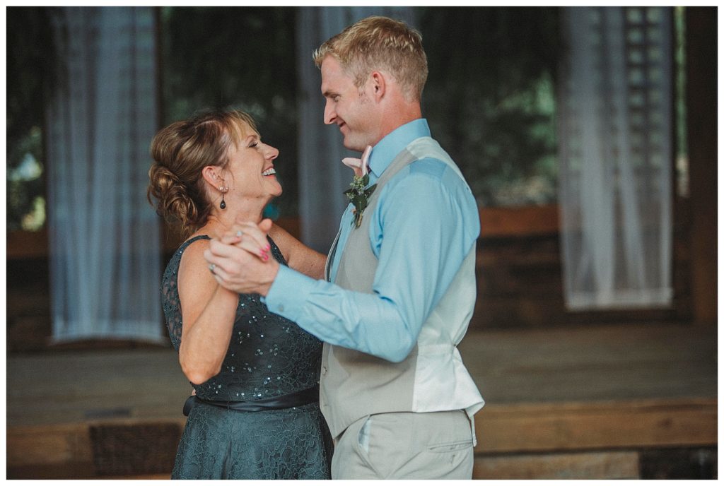 groom dancing with mom at wedding