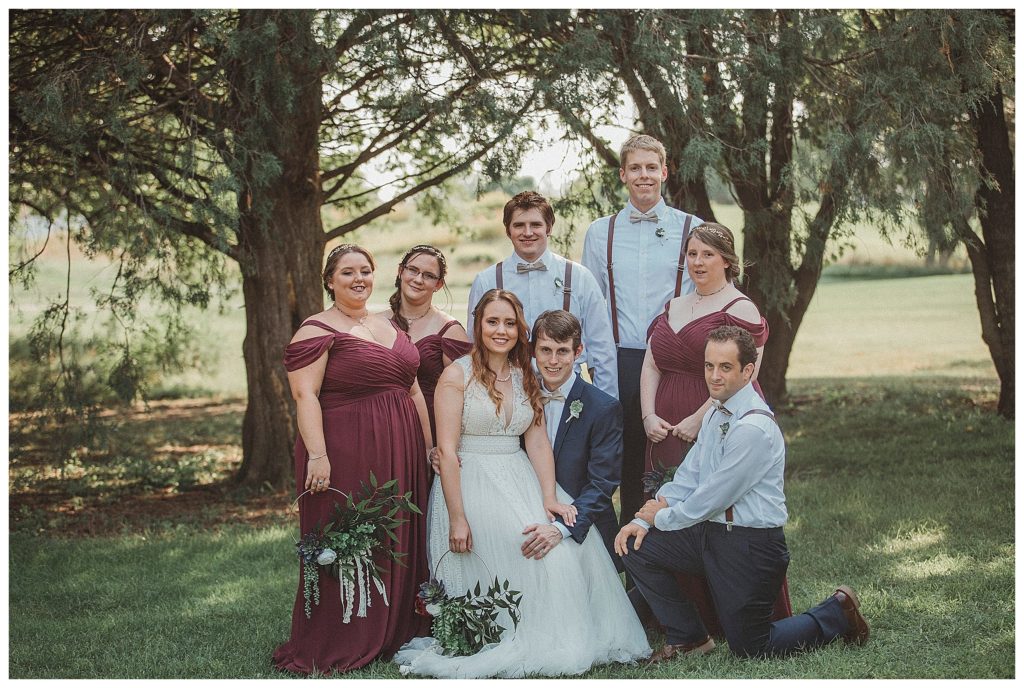 the entire bridal party under the trees