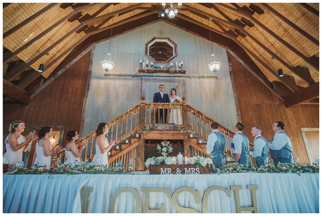 bride and groom entering their reception
