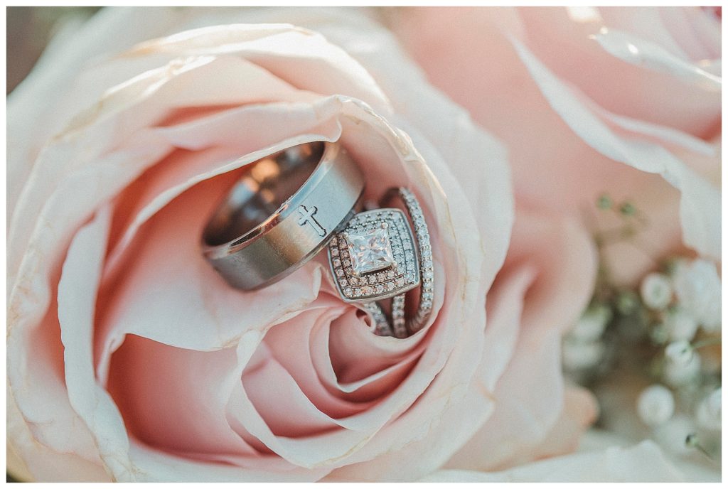 wedding rings in side pink rose