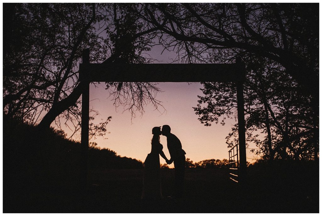 bride and groom's silhouettes at dusk