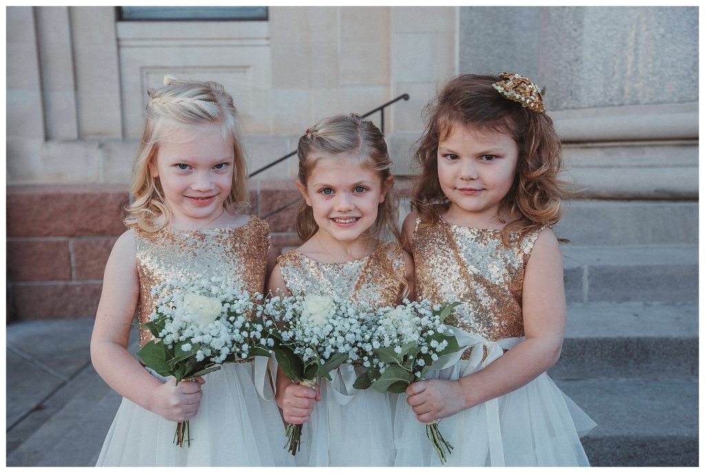 three flower girls standing together