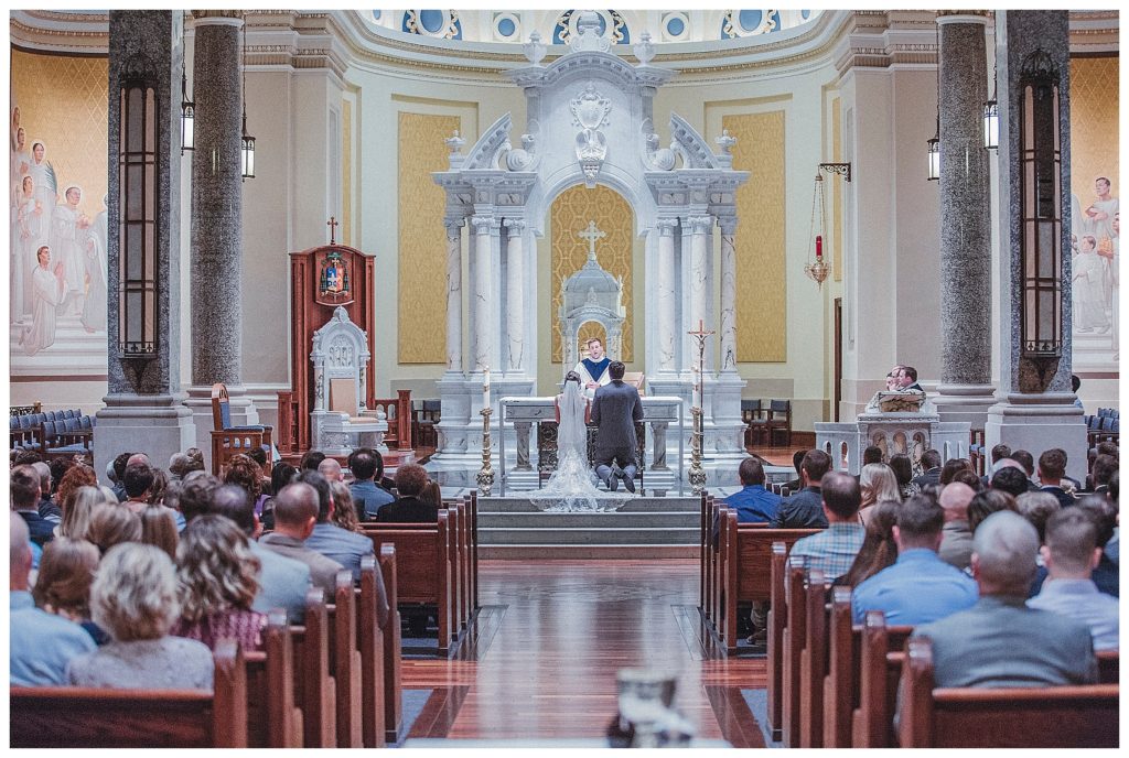 bride and groom during catholic ceremony