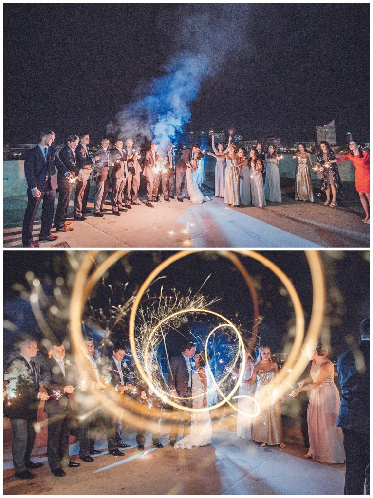 bridal party with sparklers on roof top