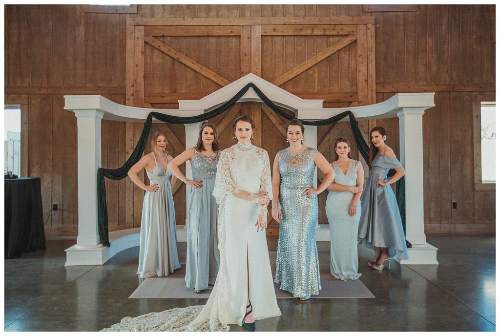 bridesmaids standing under the arbor