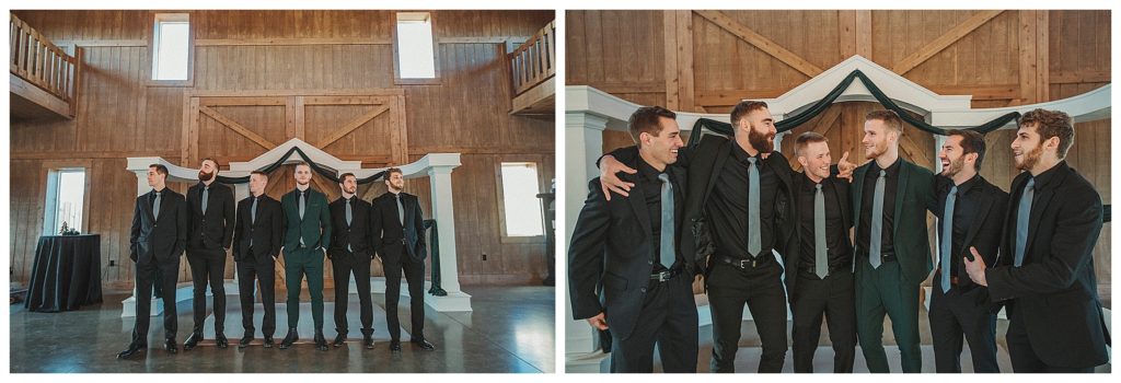 groomsmen standing together in the barn