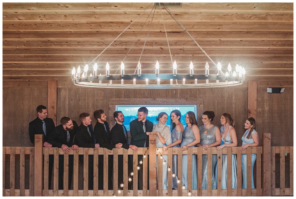 bridal party standing in barn loft
