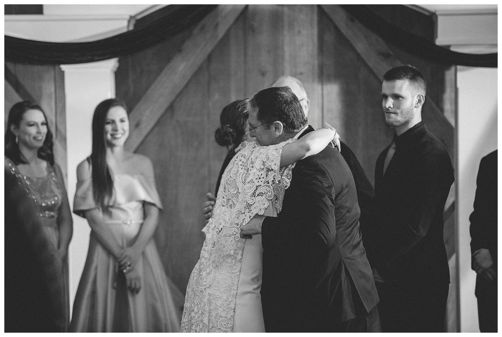 bride hugging father during ceremony