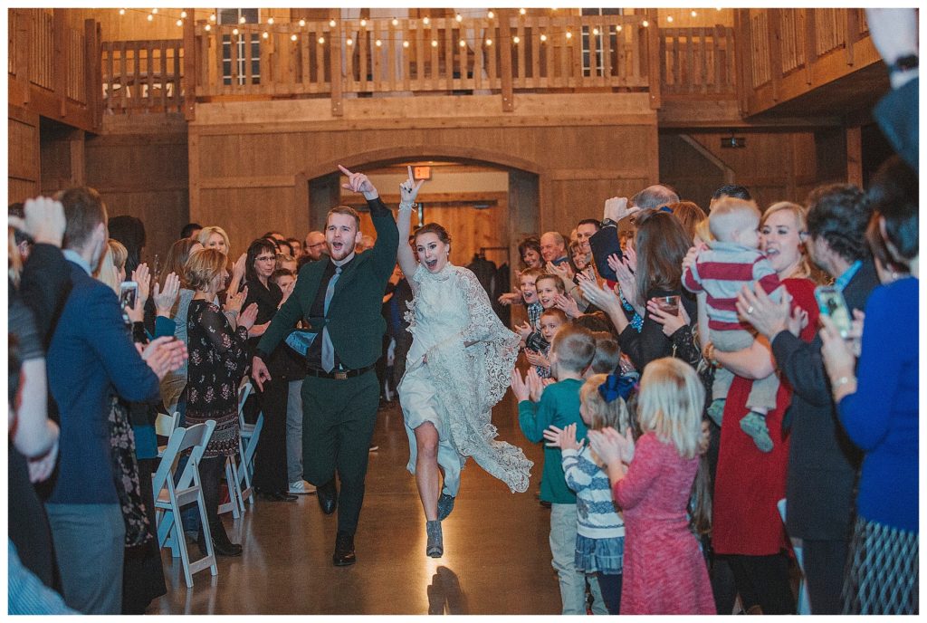 bride and groom running into their reception