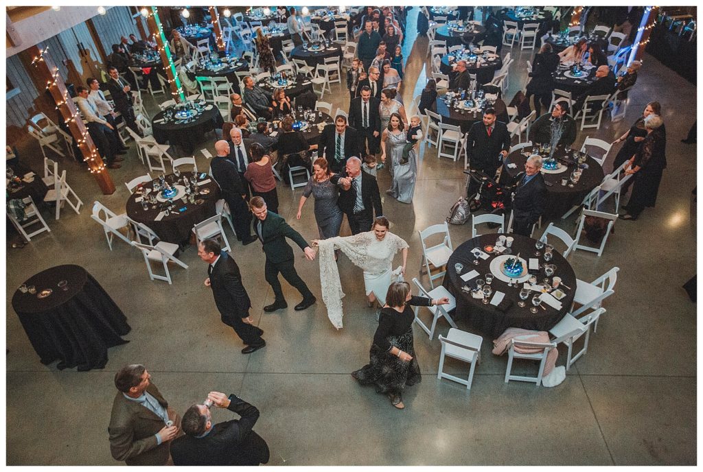 wedding party dancing the grand march in barn