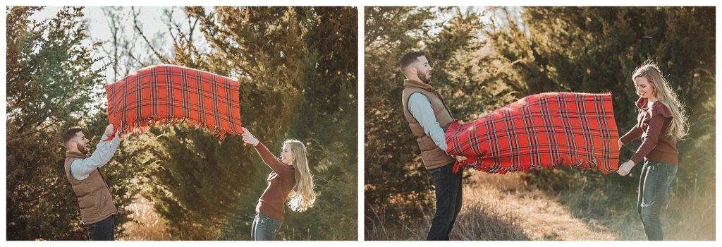 couple fluffing out blanket