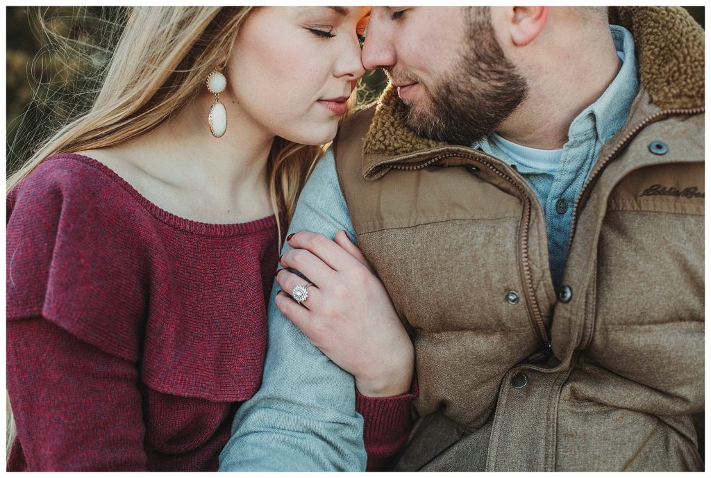 close up of couple with engagement ring