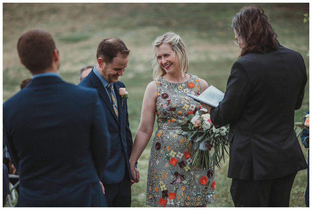 bride smiling at her groom during ceremony