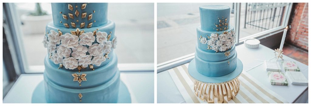 blue wedding cake next to a window